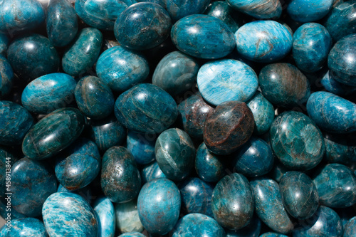 Top view of natural tumbled Apatite Stone pile under the light photo