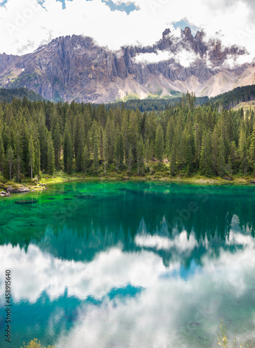 Small beautiful lake surrounded by mountains in Dolomite alps, Italy