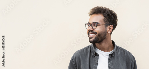 Closeup portrait of handsome smiling young man. Laughing joyful cheerful men isolated studio shot. Panoramic banner photo