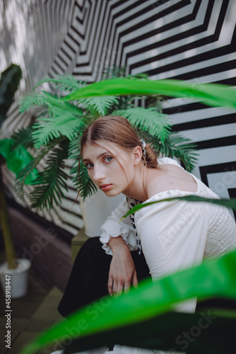 a beautiful girl in a white shirt walks around the city, a model girl in the city