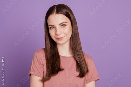 Photo of young sweet smiling girl isolated on purple background