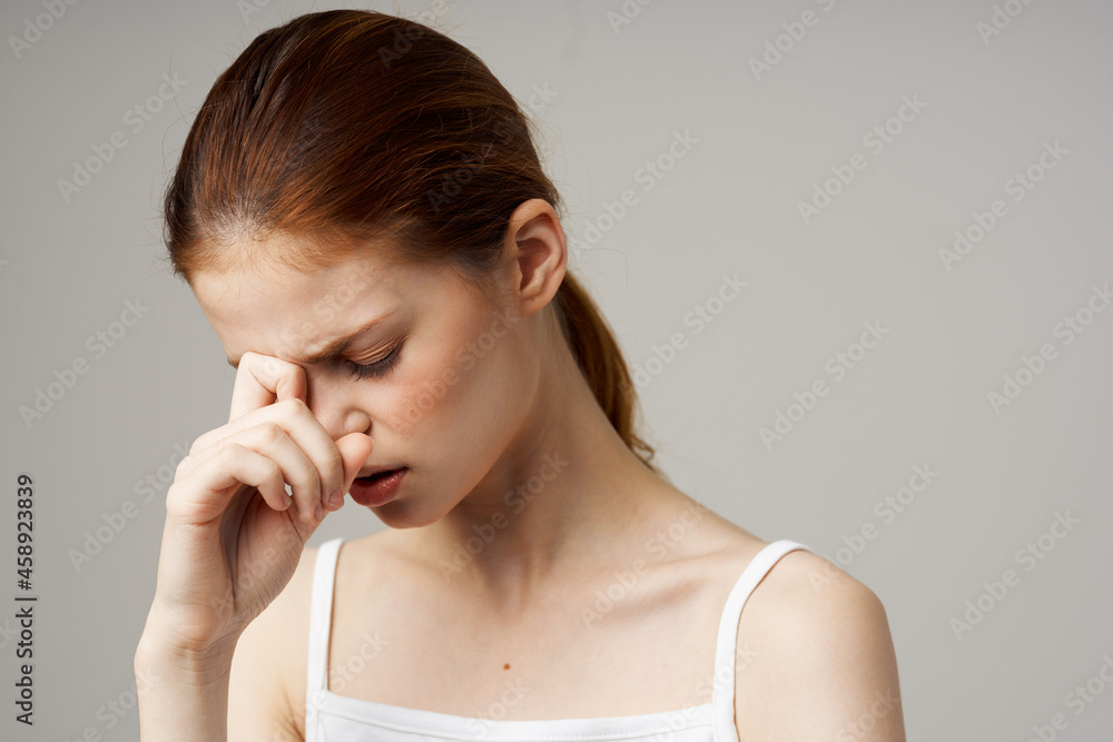 woman in white t-shirt headache health problems stress isolated background woman in white t-shirt headache health problems stress isolated background