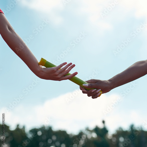 Konstfotografi Close up shot of hands of female runners passing the baton during relay competit
