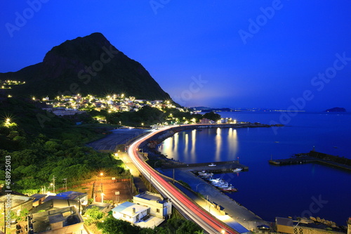Dawn landscape with fishing port and beautiful bay surrounded by mountains