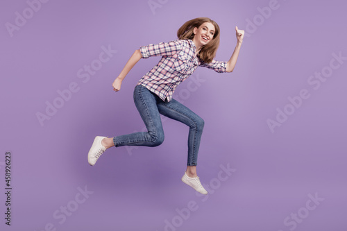 Full length side profile body size photo girl jump high go running sale discount isolated violet color background