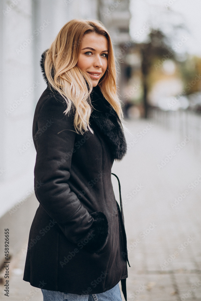 Young woman wearing jacket walking outside Young woman wearing jacket walking outside