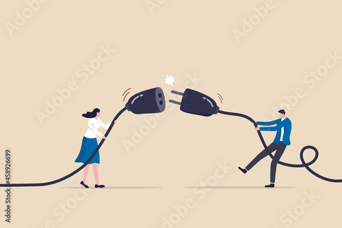 Disconnected business, broken communication, 404 or disconnect from social media distraction or monitor screen, young man and young adult woman pull electric socket plug to disconnect from internet. photo