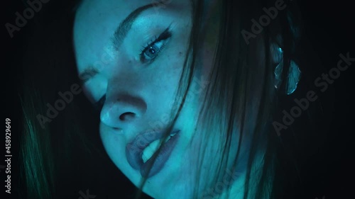 A girl holds a glowing aquarium
