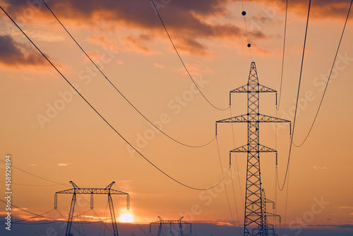 beautiful landscape with sunset over electricity poles