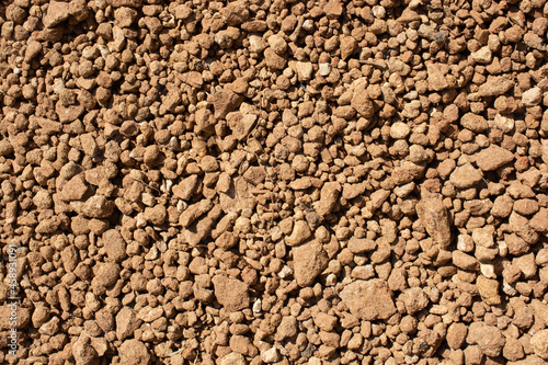 Closeup shot of brown dry laterite soil in the sun photo