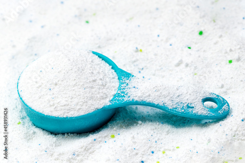 Blue cup or scoop of white powder Detergent for clothes washing