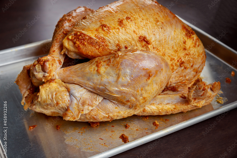 Baking sheet with raw turkey on wooden table. Baking sheet with raw turkey on wooden table.
