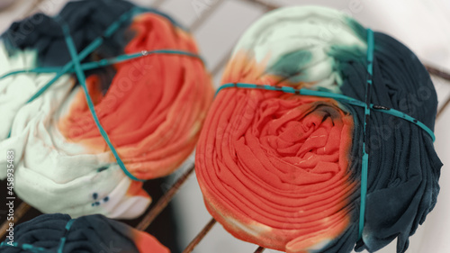 Tie dye technique by folding the clothes of a hand tie dye on cotton fabric