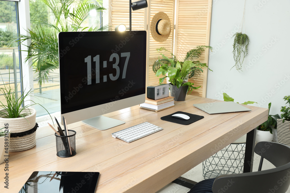Comfortable workplace with computer in light room. Interior design Comfortable workplace with computer in light room. Interior design