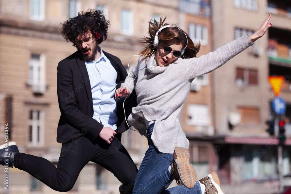 Ταπετσαρία Young business colleagues dancing together with headphones after work