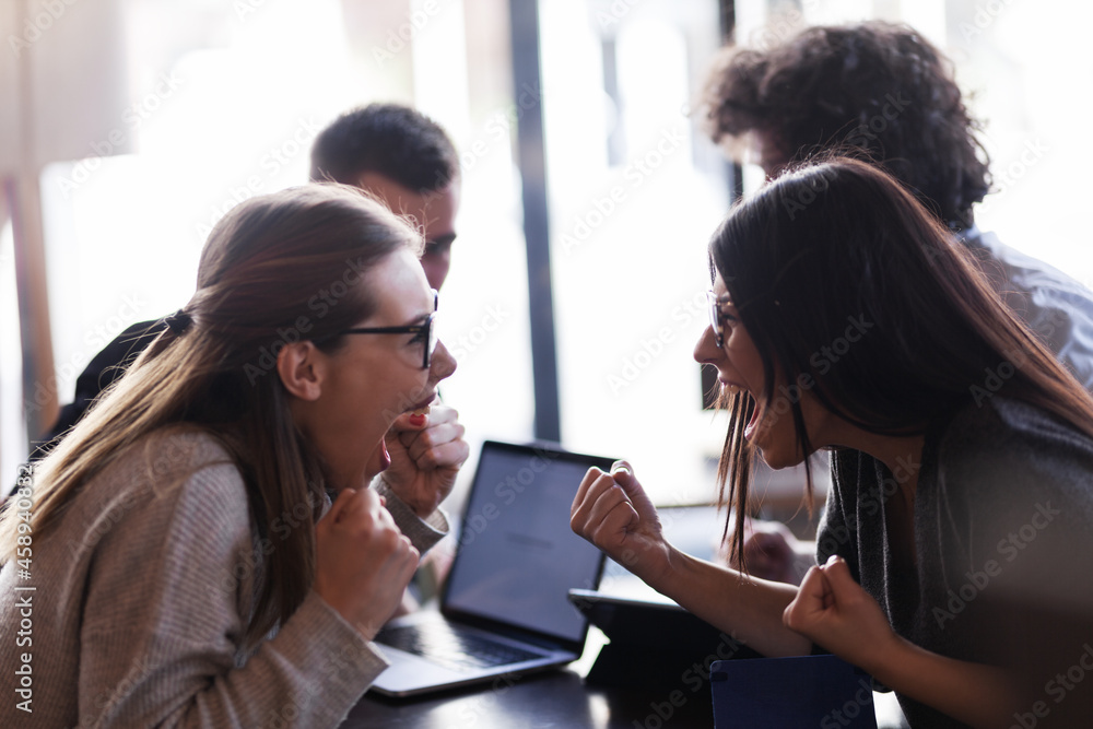 Friends having fun at a cafe bar. Smiling laughing and yelling. Celebrating success. Positive face expressions. Friends having fun at a cafe bar. Smiling laughing and yelling. Celebrating success. Positive face expressions.