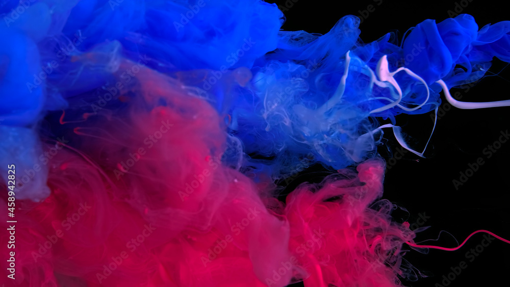 Awesome abstract background. Beautiful wallpaper for your desktop. Colored cloud of ink on a black background. Drops of scarlet, white and blue ink in water.