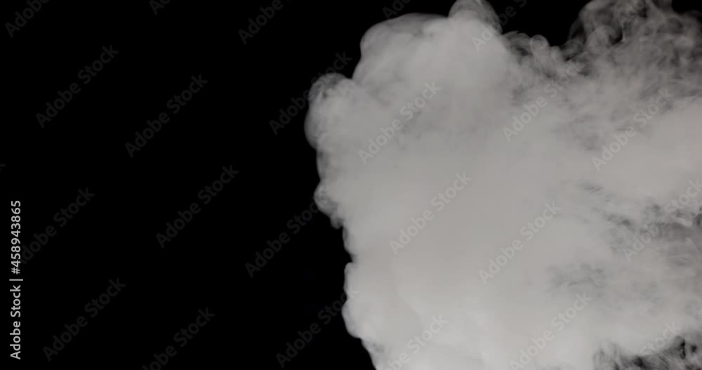 Smoke moving against a black background. Smoke moving against a black background.