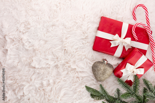 Christmas composition. Gift box, christmas decorations on wool background. Flat lay, top view, copy space.
