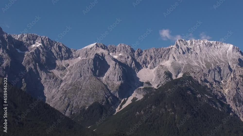 Close up Drone view on a massive mountain side in the austrian alps while it's descending downwards to land Close up Drone view on a massive mountain side in the austrian alps while it's descending downwards to land