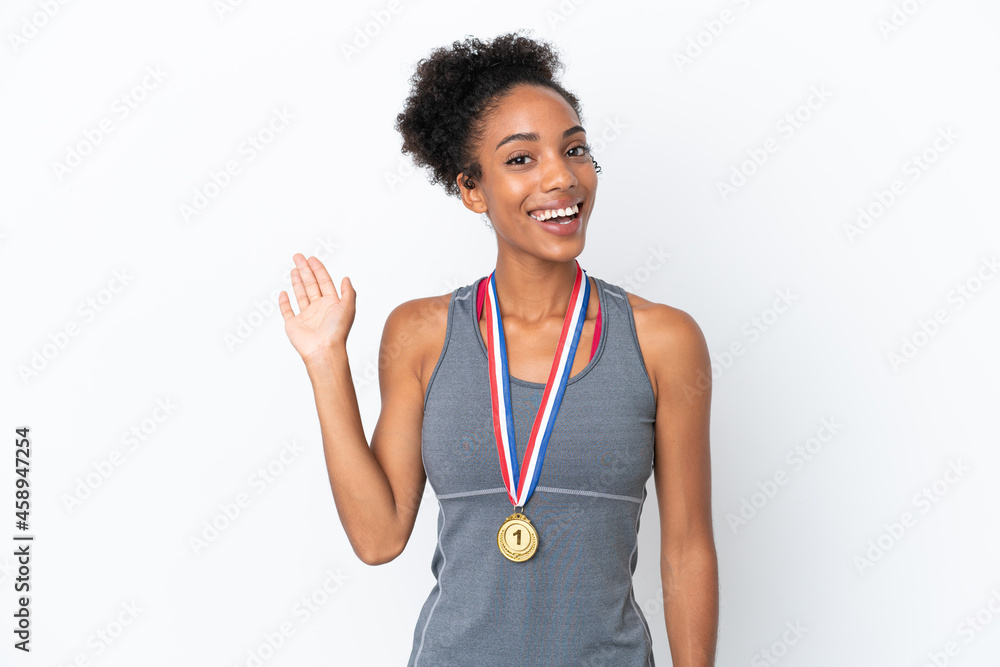 Young African American woman with medals isolated on white background saluting with hand with happy expression Young African American woman with medals isolated on white background saluting with hand with happy expression