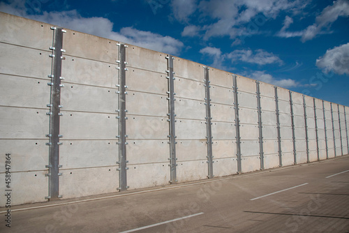 Wallpaper Mural Southampton, England, UK, 2021.  A long high security wall of conrete panels bolted together. Torontodigital.ca