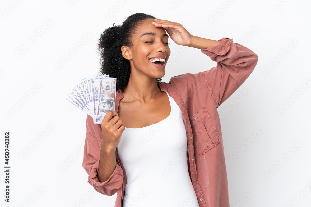 Young African American woman taking a lot of money isolated on white background smiling a lot