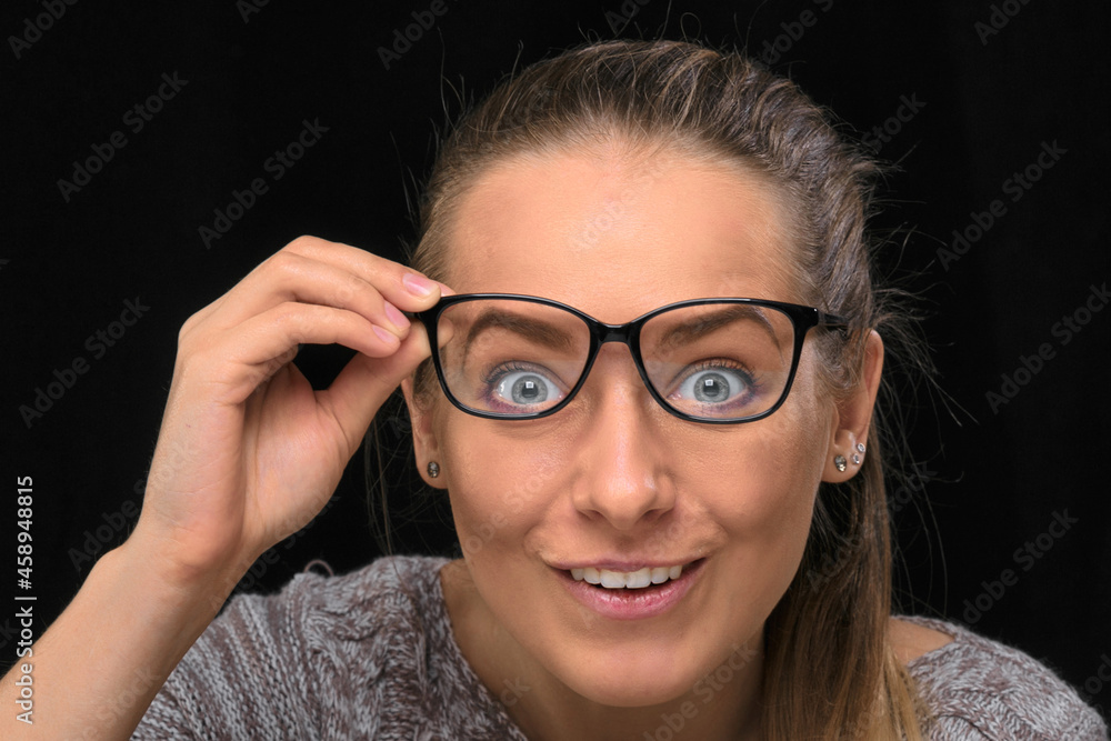 portrait of a beautiful girl with glasses on a black background. portrait of a beautiful girl with glasses on a black background.