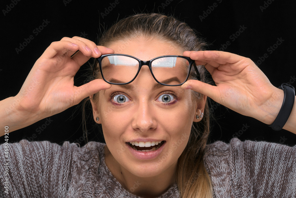 portrait of a beautiful girl with glasses on a black background. portrait of a beautiful girl with glasses on a black background.