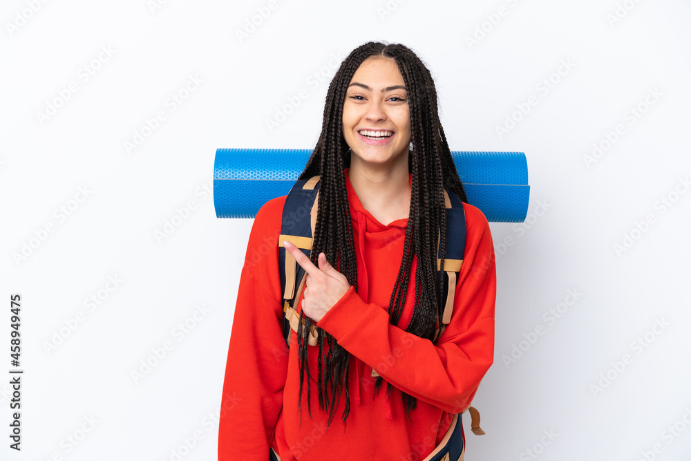 Hiker teenager girl with braids over isolated white background pointing to the side to present a product Hiker teenager girl with braids over isolated white background pointing to the side to present a product