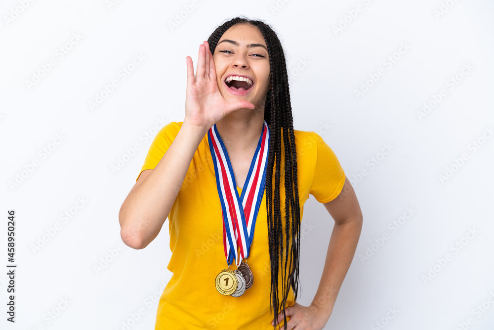 Teenager girl with braids and medals over isolated pink background shouting with mouth wide open Teenager girl with braids and medals over isolated pink background shouting with mouth wide open