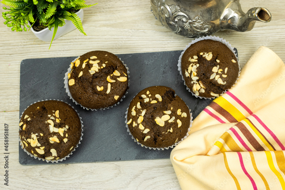 blackboard chocolate nuts muffins, Arabic teapot on wood table
