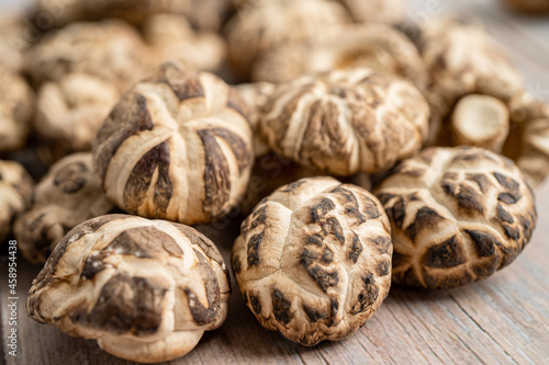 Dried shiitake mushroom on wooden background. Healthy food.