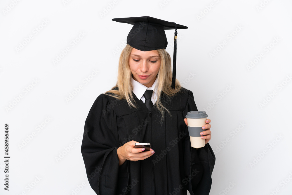 Young university graduate caucasian woman isolated on white background holding coffee to take away and a mobile Young university graduate caucasian woman isolated on white background holding coffee to take away and a mobile