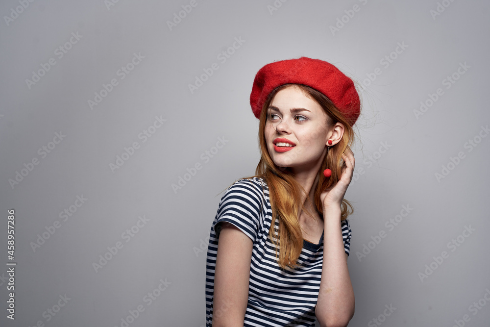 pretty woman in a striped t-shirt red lips gesture with his hands summer pretty woman in a striped t-shirt red lips gesture with his hands summer