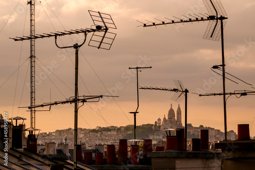 Sacré-Cœur Basilica viewed through television aerial antennae and apartment rooftops. photo