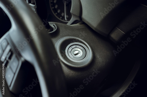 Ignition lock on the steering wheel, close-up. Starting and Stopping Car Engine with Ignition Key © natavilman