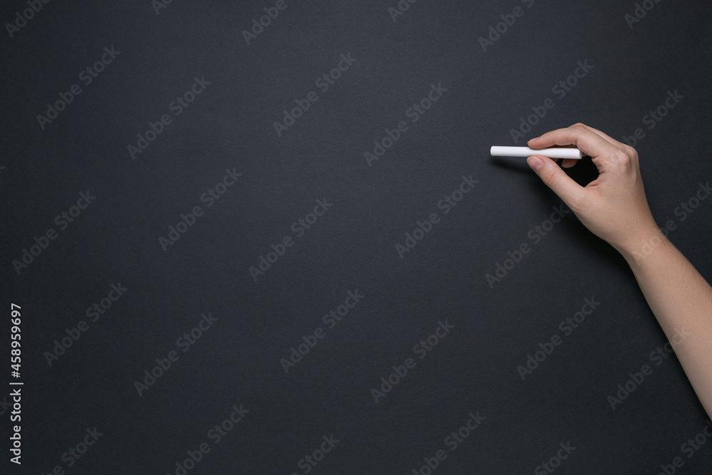 hand writes with chalk on a chalkboard, concept of learning, primary school and education, mock-up for design, place for text hand writes with chalk on a chalkboard, concept of learning, primary school and education, mock-up for design, place for text