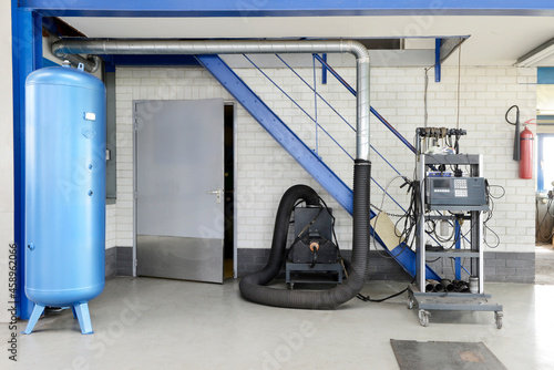 A garage or auto repair shop air pressure valve with compressor machine photo