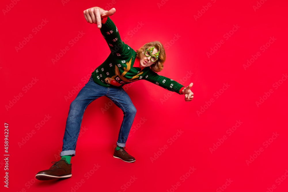 Full length body size view of attractive funky cool guy dancing fooling isolated over bright red color background Full length body size view of attractive funky cool guy dancing fooling isolated over bright red color background