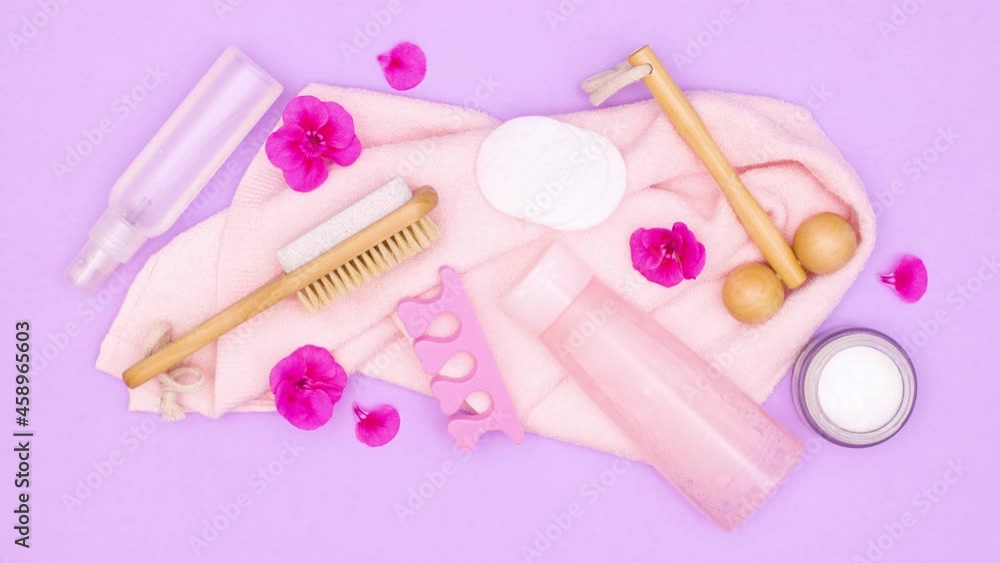 Spa relaxing skin care products appear on towel on purple theme. Stop motion Spa relaxing skin care products appear on towel on purple theme. Stop motion