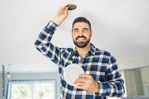 Portrait of an electrician happy worker at work