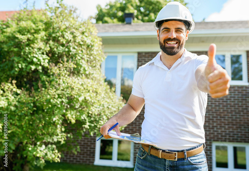 man with a white hard hat holding a clipboard, inspect house photo
