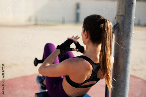 Beautiful athlete woman training outdoors. Young fit woman doing exercise outside.