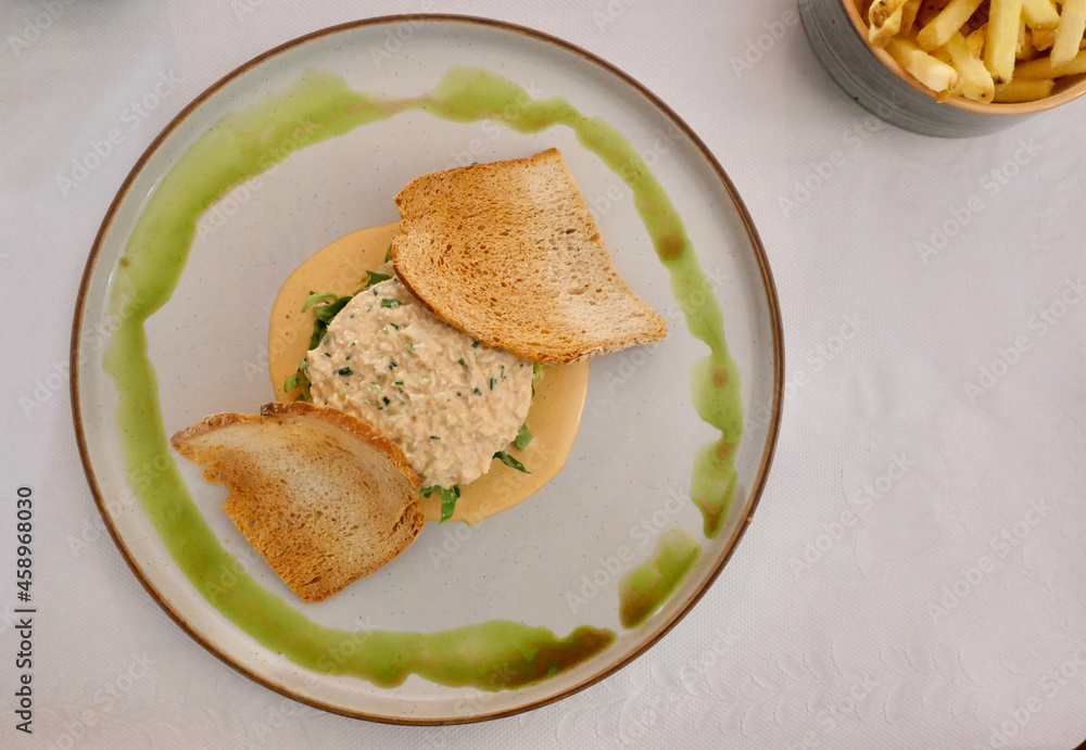 Culinary image showing crab on a bed of lettuce with sauce Culinary image showing crab on a bed of lettuce with sauce
