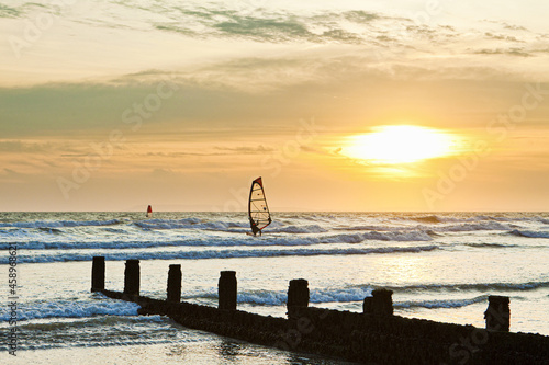Sunset over the English Channel with windsurfers, viewed from the south coast resort of Bracklesham, Sussex UK photo
