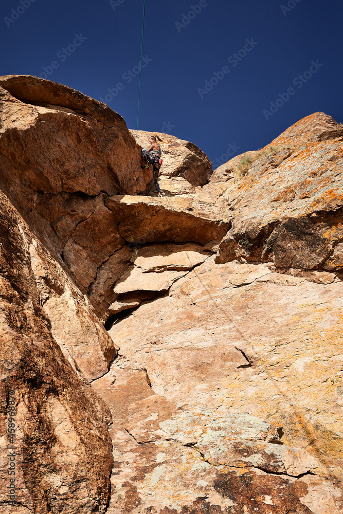 Young woman climb the rock in Kazakhstan