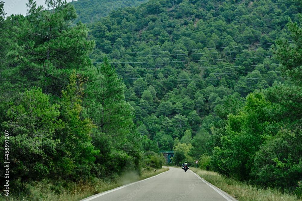 Motorcycle rides through the narrow and serpentine curves of the Pyrenees