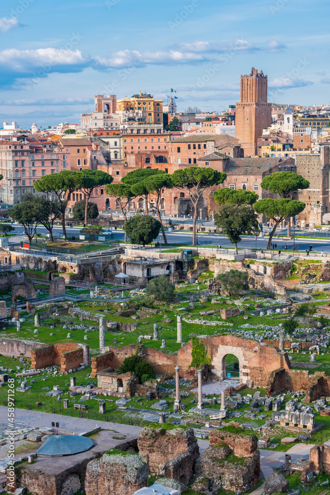 Ruins of ancient roman forum with modern and medieval city of Rome in the background