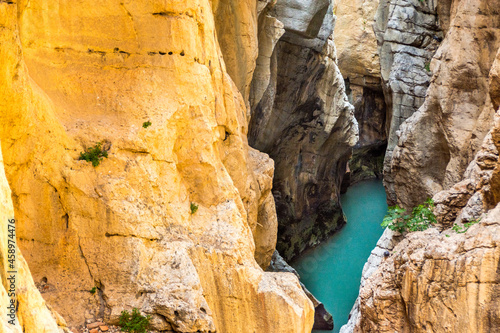 Fototapeta Naklejka Na Ścianę i Meble -  On the Caminito del Rey. A view of the golden steep cliffs of the narrow and vertiginous canyon of the Gaitanes gorges